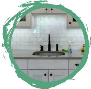 a green brushstroke background with a circular image of a kitchen faucet